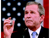 President Bush holds up the badge of Port Authority police officer George Howard while addressing a joint session of Congress in Washington on September 20. Bush
says he will carry with him the shield that belonged to Howard, killed trying to help others at the World Trade Center, and which is given to the president by the officer's mother. "This is my reminder of lives that ended and a task that does not end," says Bush. "I will not forget this wound to my country or those who inflicted it."