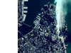 A satellite image of Manhattan taken at 11:43 a.m. on September 12 by Space Imaging's IKONOS satellite shows a column of white dust and smoke where the World Trade Center once stood.
