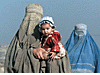 An Afghan mother carries her daughter at a refugee camp near
the Pakistan capital of Islamabad, November 8, 2001.